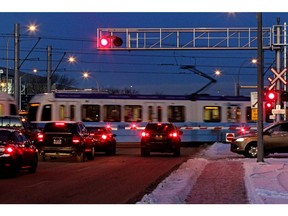 Vehicles wait as a southbound LRT train leaves the NAIT station during the evening rush-hour, Dec. 15, 2015.