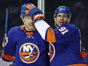 John Tavares of the New York Islanders congratulates Anders Lee on his goal against the Tampa Bay Lightning at the Barclays Center on March 22, 2018. (Bruce Bennett/Getty Images)