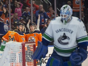Ethan Bear, Kris Russell and Ryan Nugent-Hopkins of the Edmonton Oilers,celebrate a second period goat by Ryan Nugent-Hopkins against the Vancouver Canucks at Rogers Place in Edmonton on April 7, 2018. Photo by Shaughn Butts / Postmedia