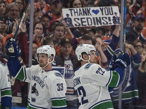 Henrik Sedin and Henrik Sedin of the Vancouver Canucks are acknowledged by the crowd at Rogers Place in Edmonton on April 7, 2018. The Sedin's were playing their final NHL game. Photo by Shaughn Butts / Postmedia