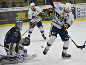 Spruce Grove Saints Chase Olsen (27) tries to deflect the puck on Wenatchee Wild goalie Austin Park (35) during game 3 of the Doyle Cup at Grant Fuhr Arena in Spruce Grove, May 1, 2018.