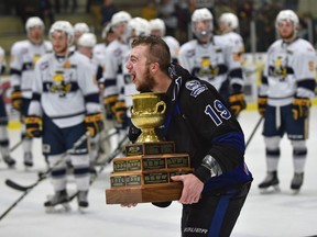 Holding the Doyle Cup Wenatchee Wild captain AJ Vanderbeck celebrates defeating the Spruce Grove Saints who watch on during the Doyle Cup at Grant Fuhr Arena in Spruce Grove, May 4, 2018.