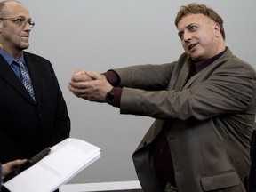 Edmonton Police Commission Citizen Award recipient Steve Lount, right, recounts a 2017 incident where he intervened when a London Drugs clerk was attacked by a man with scissors. Lount, Curtis Pyck, left, and Trevor Nathan, not shown, received Edmonton Police Commission Citizen Award's for their action during the incident on Friday, May 11, 2018.