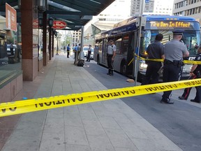 Police cordon off an area outside Tim Hortons at 10150 Jasper Ave. after a man was apparently stabbed in the neck on Friday, May 18, 2018.