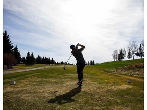 A golfer tees off at Mill Woods Golf Course in 2018.
