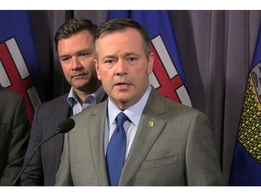 United Conservative Party Leader Jason Kenney speaks to reporters as Edmonton-Riverbend Conservative MP Matt Jeneroux looks on at the party's founding convention at the Sheraton Hotel in Red Deer on Friday, May 4, 2018.