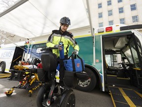 Christina Kadoglou, a primary care paramedic in the Edmonton zone, shows the equipment she carries on her Segway when working an event, such as the Heritage Festival, during an open house to kick off Emergency Preparedness Week near the Alberta legislature in Edmonton, on Thursday, May 3, 2018.