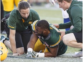 Edmonton Eskimos running back John White (30) is injured during first half CFL action against the Montreal Alouettes, in Edmonton on Friday, June 30, 2017.