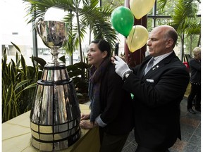 The Keeper Jeff McWhinney takes a picture of Postmedia employee Janice Ryan reflected in the Grey Cup on Thursday, May 31, 2018  in Edmonton.