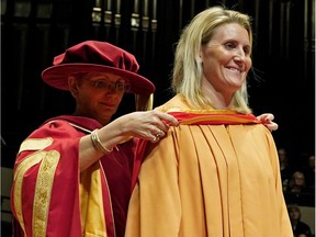 Canadian hockey player Hayley Wickenheiser (right) received an honorary diploma from Dr. Jodi Abbott (left), President & CEO of NorQuest College) in Edmonton on May 24, 2018.
