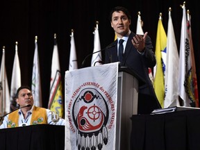 Prime Minister Justin Trudeau delivers an address at the Assembly of First Nations Special Chiefs Assembly, as National Chief Perry Bellegarde looks on, in Gatineau, Que., on Wednesday, May 2, 2018.