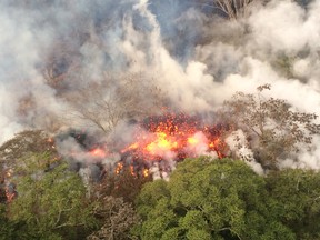 This image released by the U.S. Geological Survey on May 17, 2018 shows lava spattering from an area between fissures 16 and 20 at 8:20 a.m. HST from the Kilauea Volcano on May 16, 2018. (AFP PHOTO / US Geological Survey/HO)