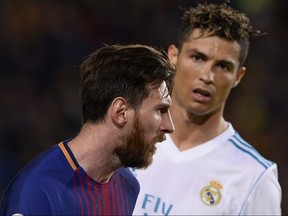 Real Madrid forward Cristiano Ronaldo (right) looks at Barcelona forward Lionel Messi during Spanish league action at Camp Nou stadium in Barcelona on May 6, 2018.