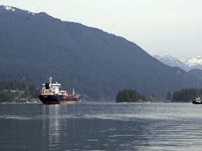 This May 3, 2018 photo shows the Kirkeholmen oil tanker anchored outside the Kinder Morgan Inc. Westridge oil terminal in Vancouver, Canada, at the end of the Trans Mountain pipeline that begins in northern Alberta. A project to expand the pipeline would triple the capacity of the existing pipeline to ship oil across the snow-capped peaks of the Canadian Rockies and to the Pacific Ocean, resulting in a seven-fold increase in the number of tankers in an environmentally sensitive area dependent on tourism and fishing. (AP Photo/Jeremy Hainsworth) ORG XMIT: CPT501