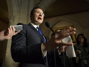 Conservative MP Pierre Poilievre speaks to reporters about Minister of Finance Bill Morneau in the in the foyer of the House of Commons on Parliament Hill in Ottawa on Tuesday, Nov. 28, 2017. (THE CANADIAN PRESS/Justin Tang)
