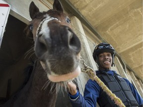 Rey Williams, 19, is tall for a jockey at six feet, but he feels his long arms and reach encourage the horses to run to their potential. Taken at the barns at Northlands Park with the horse Oved on May 3, 2018.