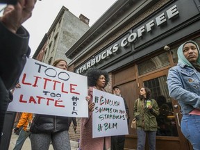Protesters gather outside of a Starbucks in Philadelphia, Sunday, April 15, 2018, where two black men were arrested after employees called police to say the men were trespassing.