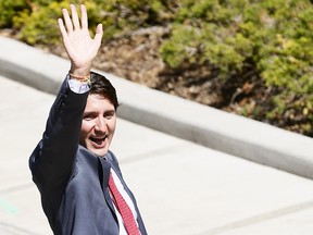 Prime Minister Justin Trudeau waves to Kinder Morgan pipeline supporters after announcing funding for Calgary's new Green Line on Tuesday May 15, 2018.