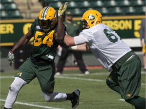 Alex Bazzie (54) and Colin Kelly (67) take part in Edmonton Eskimos training camp at Commonwealth Stadium, in Edmonton Monday May 21, 2018.