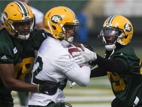 Blair Smith, left, Alex Taylor, middle and Nick Taylor (39) take part in an Edmonton Eskimos practice at Commonwealth Stadium, in Edmonton Monday June 4, 2018.