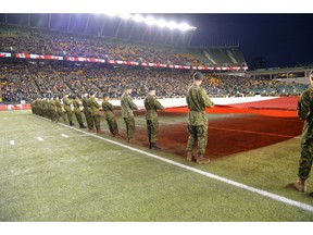 Canadian Armed Forces members display the Canadian flag during an Eskimos game last season.