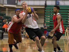 Former Alberta Golden Bears basketball player Jordan Baker, centre, plays in a three-on-three basketball tournament at the Saville Centre on Saturday, June 2, 2018.