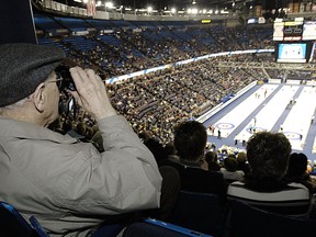 Fred Lowther from Edmonton keeps an eye on the action with his Binoculars out at the 2005 Edmonton Tim Hortons Brier event out at Rexall Place.