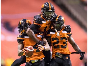 B.C. Lions' Garry Peters, from left to right, Odell Willis and Anthony Thompson celebrate Peters' interception against the Montreal Alouettes during the second half of a CFL football game in Vancouver, on Saturday June 16, 2018.