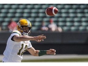 Edmonton Eskimos quarterback Mike Reilly (13) throws a pass against the Saskatchewan Roughriders during first half CFL pre-season action in Edmonton, Alta., on Sunday May 27, 2018.