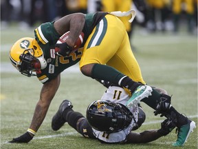 Hamilton Tiger-Cats Larry Dean (11) tackles Edmonton Eskimos C.J. Gable (2) during first half CFL action in Edmonton on Friday June 22, 2018.