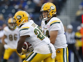 Edmonton Eskimos quarterback Zach Kline (14) fakes the handoff to Shaquille Cooper (25) during the first half of pre-season CFL action in Winnipeg Friday, June 1, 2018.