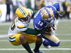 Winnipeg Blue Bombers' Adarius Bowman (12) snags the touchdown pass against Edmonton Eskimos' Maurice McKnight (40) during the first half of pre-season CFL action in Winnipeg Friday, June 1, 2018.