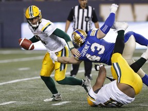 Edmonton Eskimos quarterback Danny O'Brien (9) scrambles from Winnipeg Blue Bombers' Trent Corney (43) as Eskimos' Andrew Peterson (61) goes down during the second half of pre-season CFL action in Winnipeg Friday, June 1, 2018.