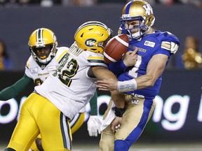 Winnipeg Blue Bombers quarterback Chris Streveler (17) fumbles the ball after getting hit by Edmonton Eskimos' Brandon Pittman (92) during the second half of pre-season CFL action in Winnipeg Friday, June 1, 2018.