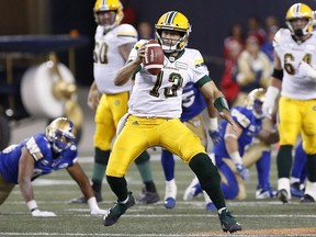 Edmonton Eskimos' quarterback Mike Reilly (13) scrambles for extra yards against the Winnipeg Blue Bombers during the first half of CFL action in Winnipeg Thursday, June 14, 2018.