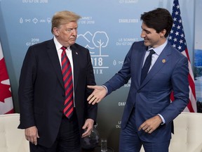 Canada's Prime Minister Justin Trudeau shakes hands with U.S. President Donald Trump during a meeting at the G7 leaders summit in La Malbaie, Que., on Friday, June 8, 2018.