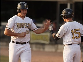 Erik Sabrowski (23) of the Edmonton Prospects celebrates a run with Dean Olson (15) against the Swift Current 57s during a Western Major Baseball League playoff game at RE/MAX Field in Edmonton, Alberta on Tuesday, August 15, 2017.
