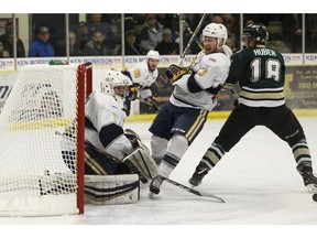 Spruce Grove Saints defenceman Sean Comrie (3) battles Okotoks Oilers' Carter Huber (18) during the second period of Game 3 of the AJHL finals at Grant Fuhr Arena in Spruce Grove, on Monday, April 16, 2018.