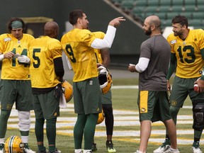 The quarterbacks chat during Edmonton Eskimos training camp at Commonwealth Stadium in Edmonton, on Tuesday, May 29, 2018. Photo by Ian Kucerak/Postmedia