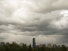 A thunderstorm rolls over downtown and the Pearl Tower condo building, as seen from Emily Murphy Park, in Edmonton, on Monday, June 4, 2018. Photo by Ian Kucerak/Postmedia