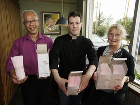 Hong Vu, left, Adam Stoyko and Kim Franklin hold boxes of straws they will return as the Highlevel Diner cuts down on plastic waste by phasing out plastic straws in Edmonton, on Sunday, June 10, 2018.