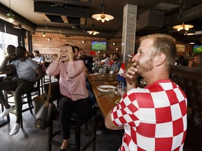 Croatia supporters Ivana (left) and Dom and their friends cheer during the World Cup game between Croatia and Nigeria at Urban Tavern in Edmonton, on Saturday, June 16, 2018. Croatia won 2-0. Photo by Ian Kucerak/Postmedia