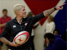 Retired rugby player Jennifer Kish talks with students at W.P. Wagner High School in Edmonton on June 6, 2018. An event was held at the school to recognize the achievements of the former Canadian rugby sevens captain and Edmonton Olympian.