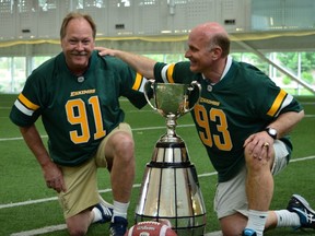 Jackie Parker Jr. and Jeff McWhinney, right, meet up at the Commonwealth Stadium field house on Saturday, June 2.