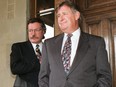 Rod Love stands behind Alberta Premier Ralph Klein on the front steps of the Alberta Legislature in the 1990's.