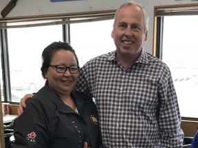 Edmonton Eskimos president and CEO gives his jacket to a fan at the airport in Inuvik.