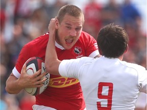 Canada's Nick Blevins (L) is tackled by Russia's Alexey Shcherban during International men's Rugby action between Canada and Russia in Calgary on Saturday June 18, 2016.