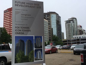 A sign announces a planned project by Edmonton's Langham Developments Ltd. on parking lots at 104 Street and 100 Avenue June 11, 2018.