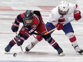 Team Brick Alberta's Alex Smyth, right, battles Team Manitoba's Jaxon Jacobson during The Brick Invitational Hockey Tournament at West Edmonton Mall on July 2, 2018.