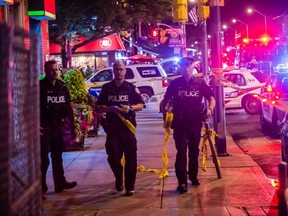 As many as nine people have been rushed to hospital with gunshot wounds after a gunman opened fire on Danforth avenue West of Logan Avenue Sunday evening shortly after 10 PM. (VICTOR BIRO PHOTO)